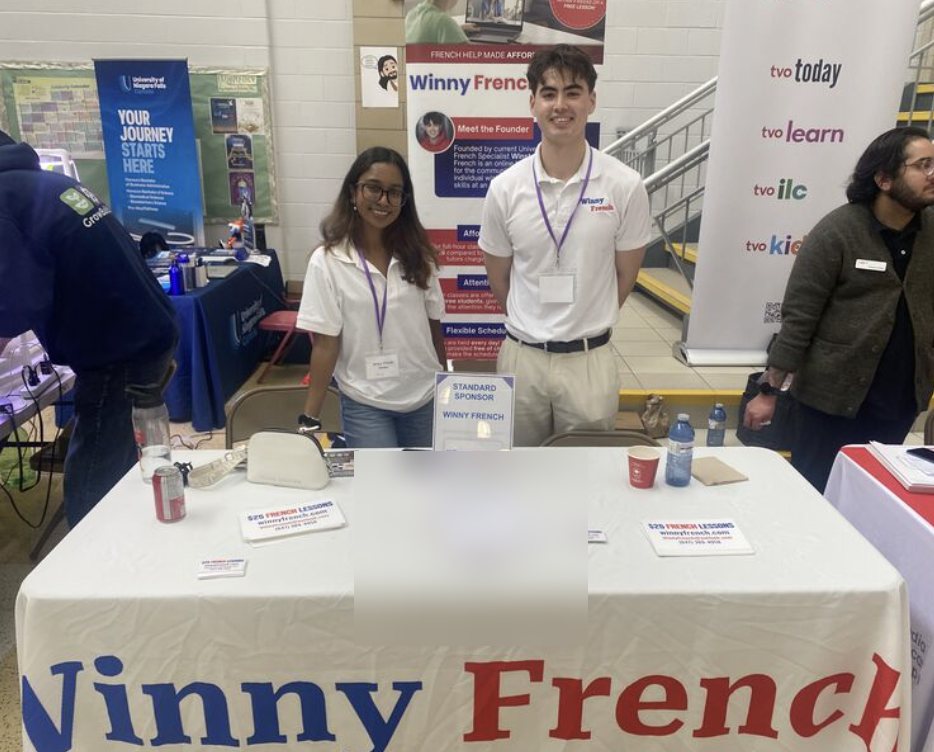 The Winny French for Kids team welcoming families at an education conference